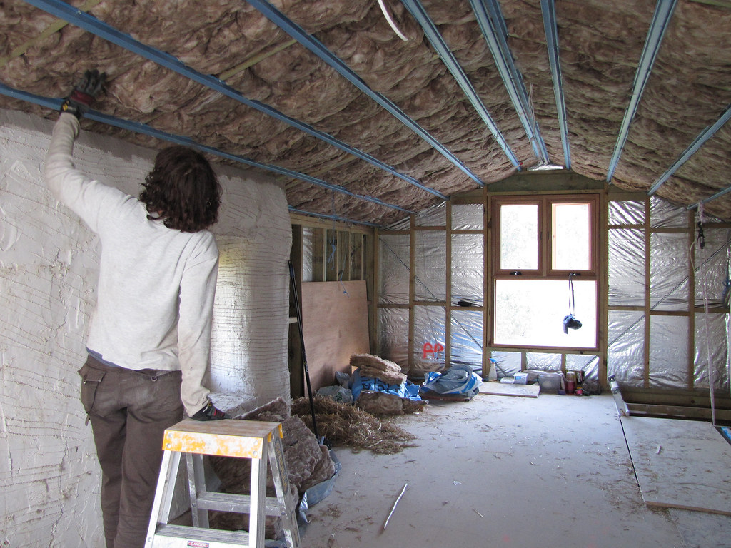 Installing roof insulation batts