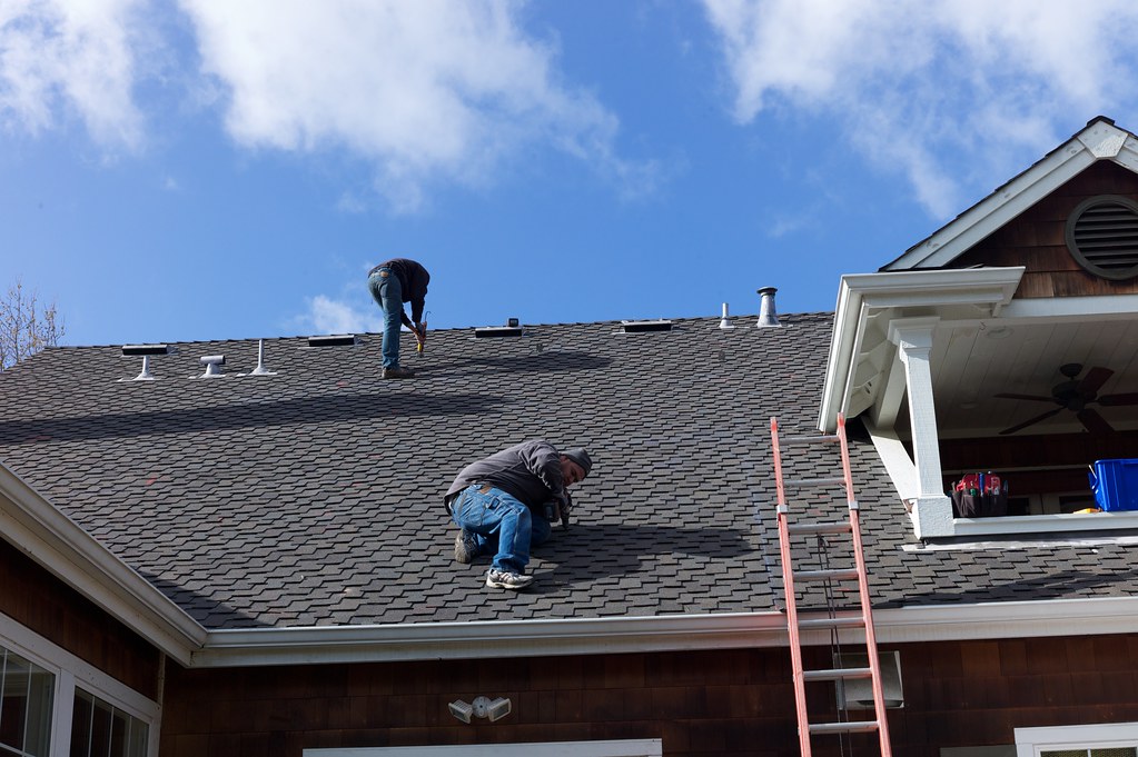Roofers securing new roof sheeting on a Perth home